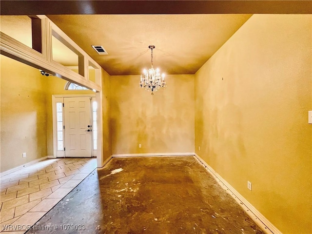 foyer entrance featuring an inviting chandelier