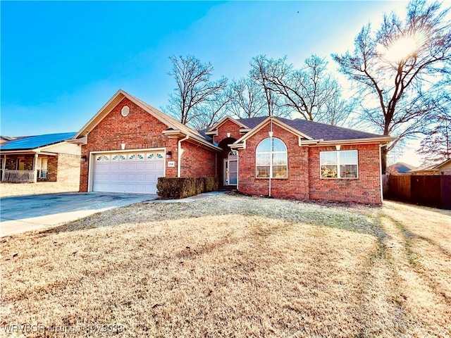 view of front of home featuring a garage and a front yard