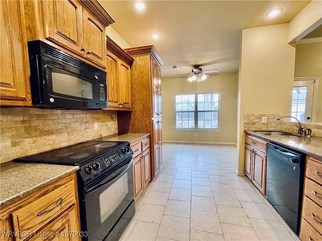 kitchen with sink, light tile patterned floors, plenty of natural light, and black appliances