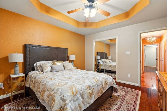 1524 Bunker Hill Ct, Van Buren, AR 72956 - bedroom featuring baseboards, a raised ceiling, dark wood-style floors, a chandelier, and ceiling fan