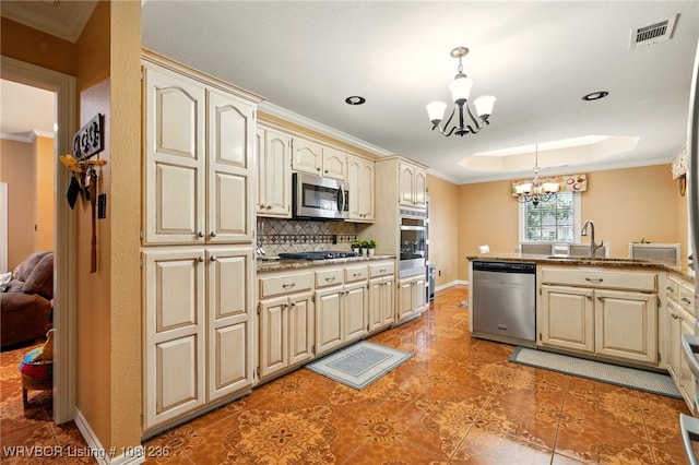1524 Bunker Hill Ct, Van Buren, AR 72956 - kitchen featuring stainless steel appliances, cream cabinets, a chandelier, a sink, and pendant lighting