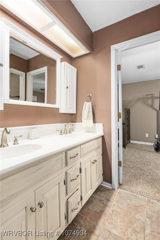 bathroom with vanity and a textured ceiling