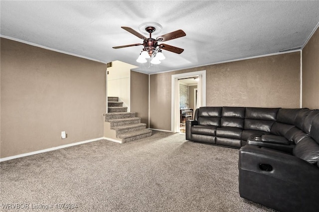 carpeted living room with a textured ceiling, ceiling fan, and crown molding