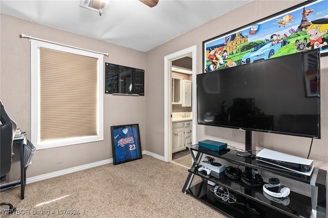 interior space with light carpet and ceiling fan