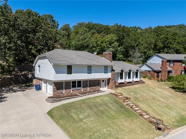 view of front of property with a garage and a front lawn