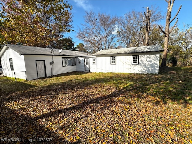 back of house with a yard