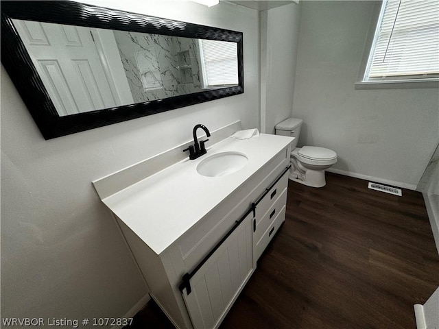 bathroom featuring hardwood / wood-style flooring, vanity, and toilet