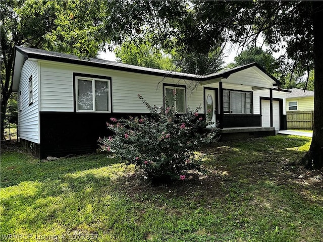 ranch-style home with a garage and a front yard