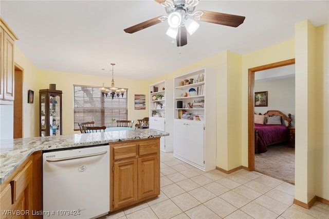 kitchen featuring hanging light fixtures, light stone countertops, dishwasher, and light tile patterned flooring