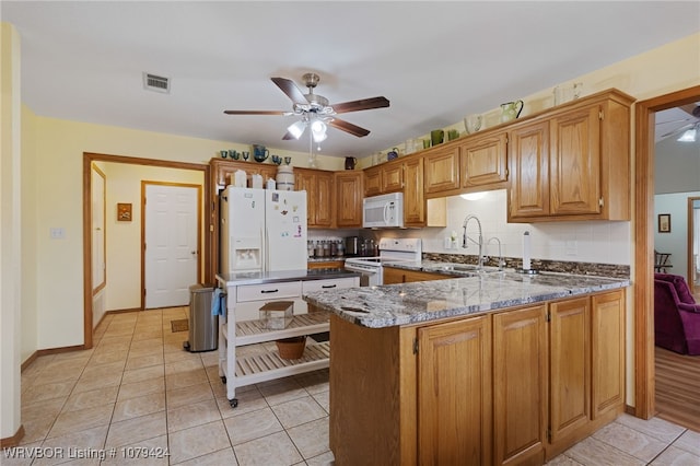 kitchen with white appliances, a sink, visible vents, and a ceiling fan