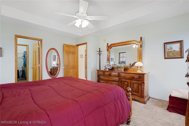 bedroom featuring light carpet, baseboards, and a ceiling fan