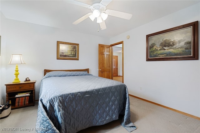 bedroom featuring light carpet, ceiling fan, and baseboards