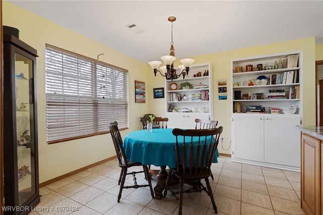 dining space featuring baseboards, built in shelves, light tile patterned flooring, and a notable chandelier