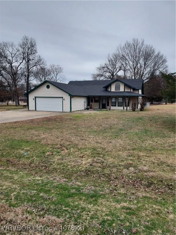 view of front of property featuring a garage and a front yard