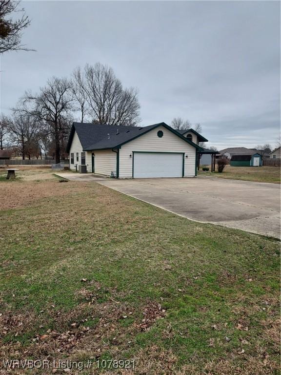 view of front of house with a garage and a front lawn