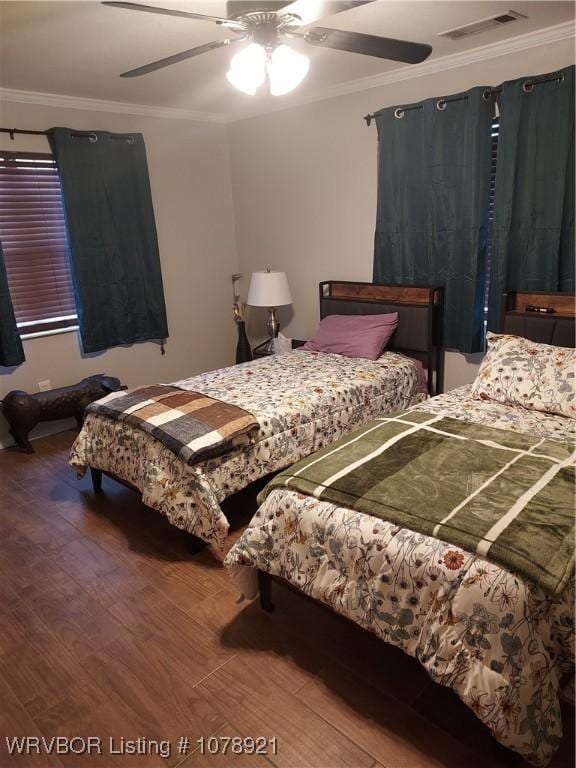 bedroom featuring wood-type flooring, ceiling fan, and crown molding