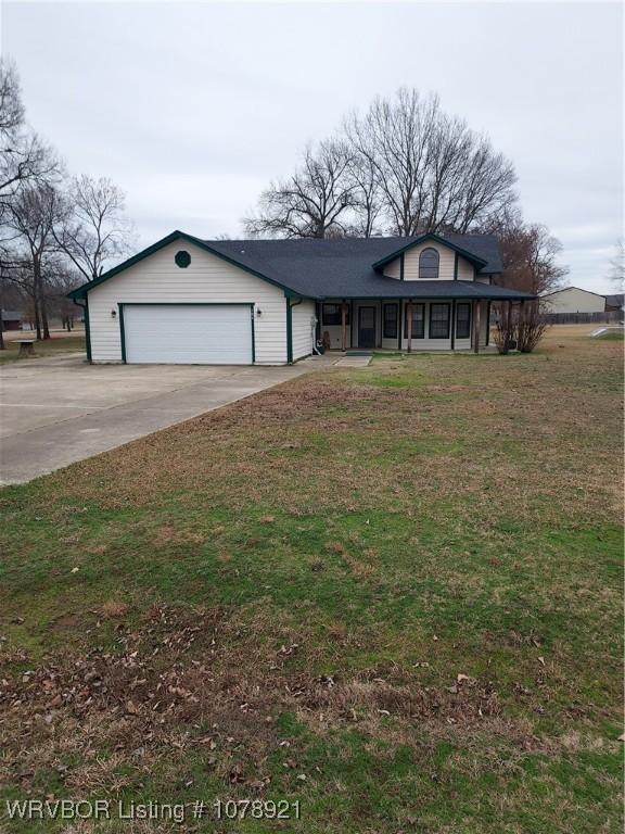 view of front of house featuring a garage and a front lawn