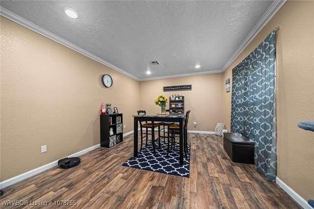 dining room featuring crown molding, dark hardwood / wood-style floors, and a textured ceiling