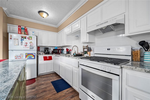 kitchen with light stone counters, white appliances, dark wood-type flooring, and white cabinets