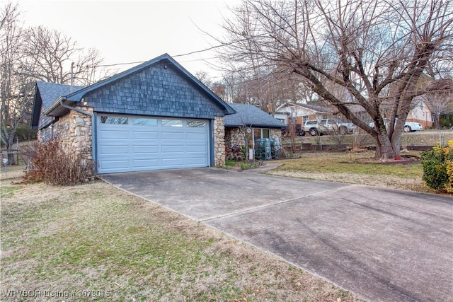 view of side of home with a garage and a yard