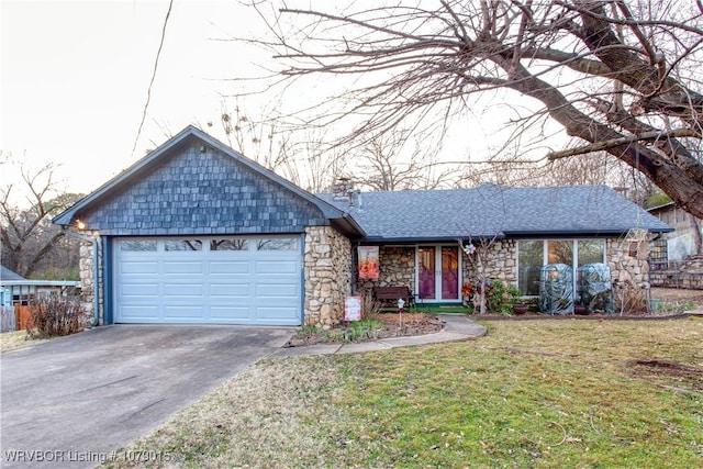 ranch-style house featuring a garage and a front lawn