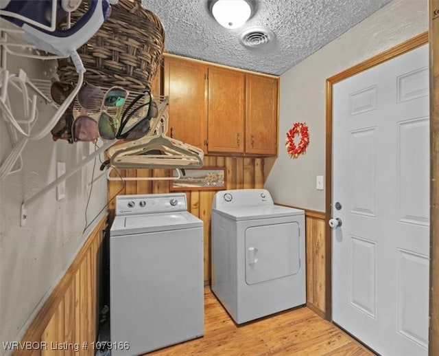 23805 270th Hwy, Howe, OK 74940 - washroom with washer and dryer, cabinet space, light wood-style floors, and a textured ceiling