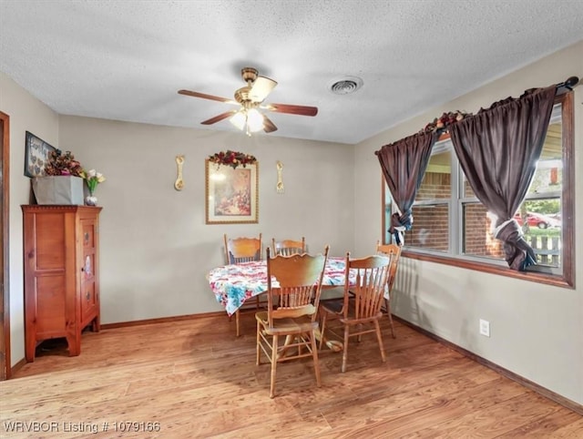 23805 270th Hwy, Howe, OK 74940 - dining space with wood finished floors, ceiling fan, a textured ceiling, and baseboards