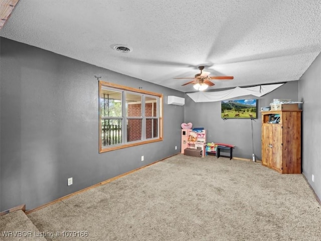 23805 270th Hwy, Howe, OK 74940 - living area with ceiling fan, a textured ceiling, an AC wall unit, plenty of natural light, and carpet flooring
