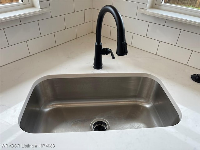 9114 Maysview Ln, Fort Smith, AR 72916 - kitchen view of a sink, light countertops, and backsplash