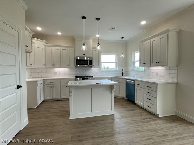 9114 Maysview Ln, Fort Smith, AR 72916 - kitchen with stainless steel microwave, dishwasher, range, tasteful backsplash, and wood finished floors