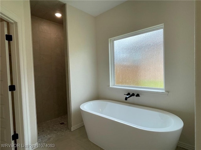 9114 Maysview Ln, Fort Smith, AR 72916 - bathroom featuring plenty of natural light, a freestanding tub, a tile shower, and tile patterned flooring
