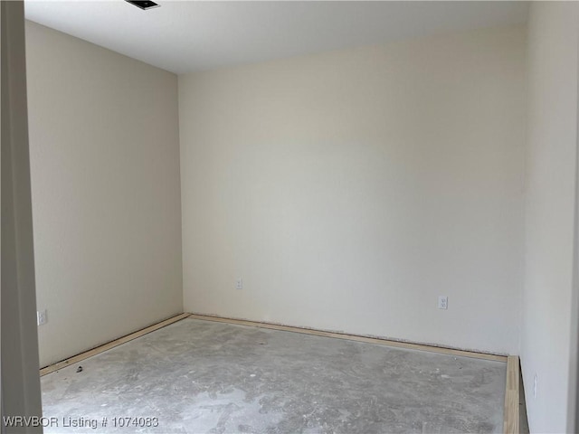 unfurnished room featuring concrete flooring