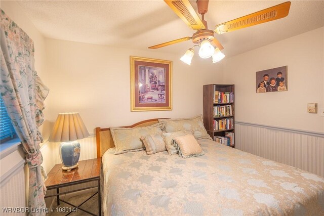 935 Florence Cir, Mulberry, AR 72947 - bedroom featuring a wainscoted wall and ceiling fan