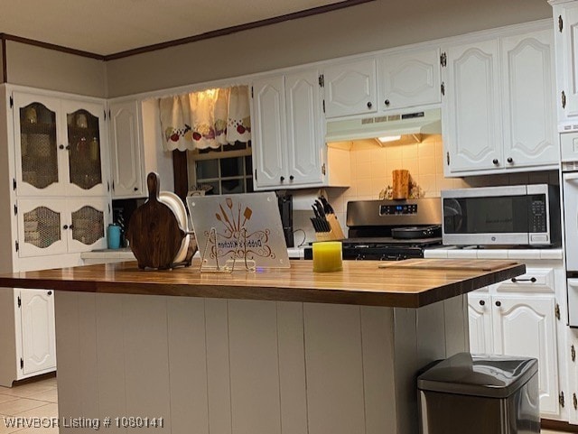 935 Florence Cir, Mulberry, AR 72947 - kitchen with appliances with stainless steel finishes, under cabinet range hood, butcher block countertops, white cabinets, and ornamental molding