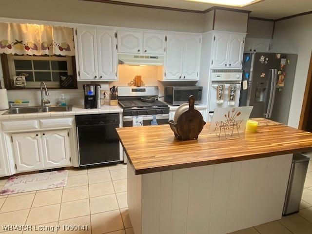 935 Florence Cir, Mulberry, AR 72947 - kitchen featuring appliances with stainless steel finishes, under cabinet range hood, a sink, butcher block counters, and light tile patterned floors