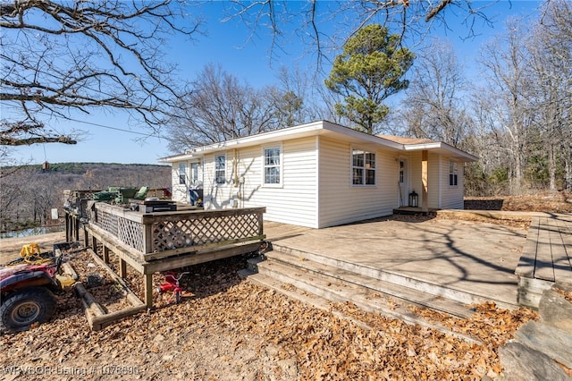 rear view of property with a wooden deck