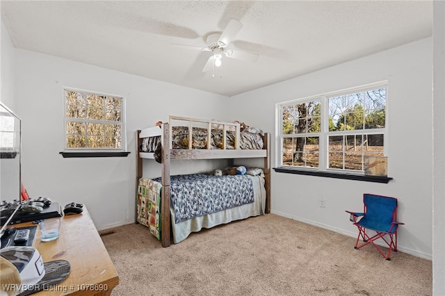 bedroom featuring ceiling fan and light carpet