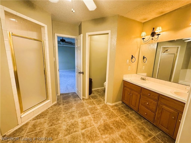 9506 Londonderry Ct, Fort Smith, AR 72908 - full bathroom featuring double vanity, a ceiling fan, a shower stall, and a textured ceiling