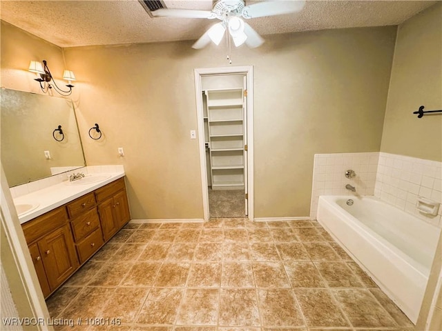 9506 Londonderry Ct, Fort Smith, AR 72908 - full bath with a textured ceiling, double vanity, ceiling fan, a bath, and a walk in closet
