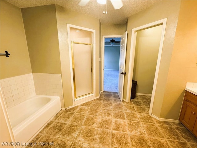 9506 Londonderry Ct, Fort Smith, AR 72908 - bathroom featuring ceiling fan, vanity, a garden tub, a stall shower, and a textured ceiling