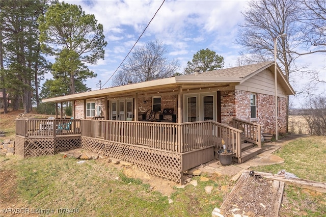 back of property with french doors and brick siding