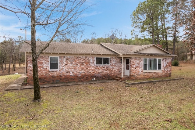 ranch-style house with crawl space, brick siding, and roof with shingles