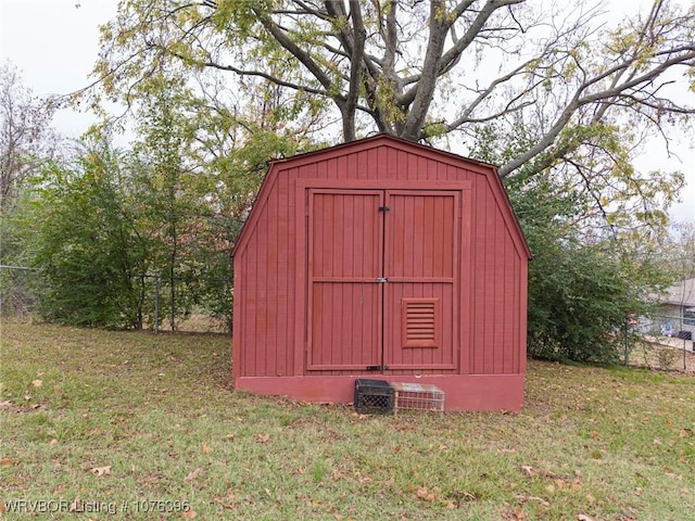 view of outbuilding featuring a lawn