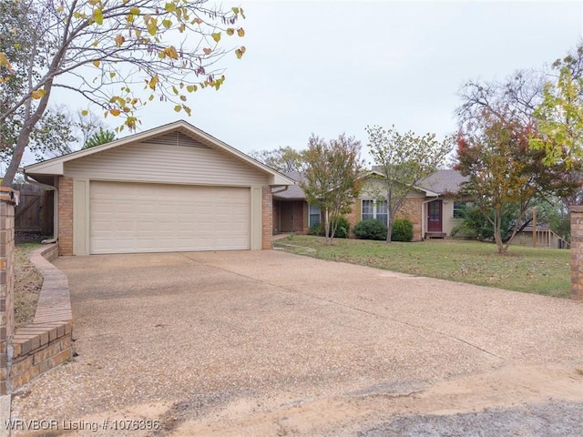 ranch-style house with a garage and a front lawn