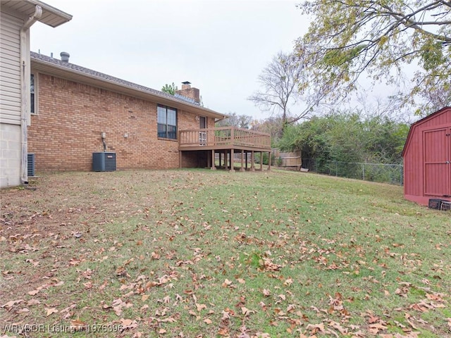 view of yard featuring a storage shed, central AC, and a deck