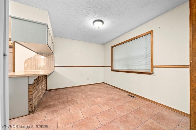 spare room featuring a textured ceiling