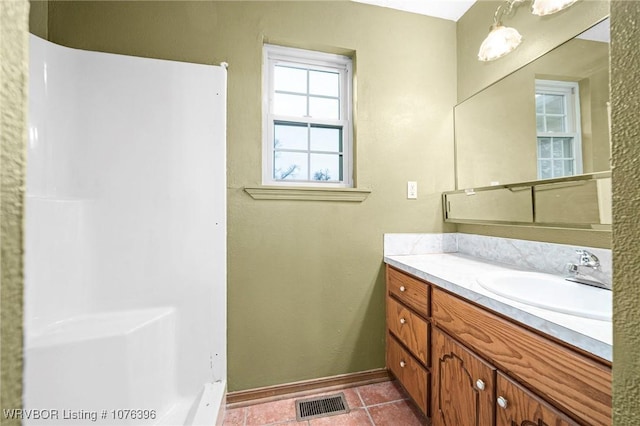 bathroom with tile patterned flooring and vanity