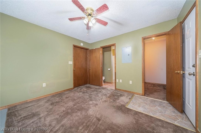 unfurnished bedroom with carpet flooring, ceiling fan, a textured ceiling, and a closet