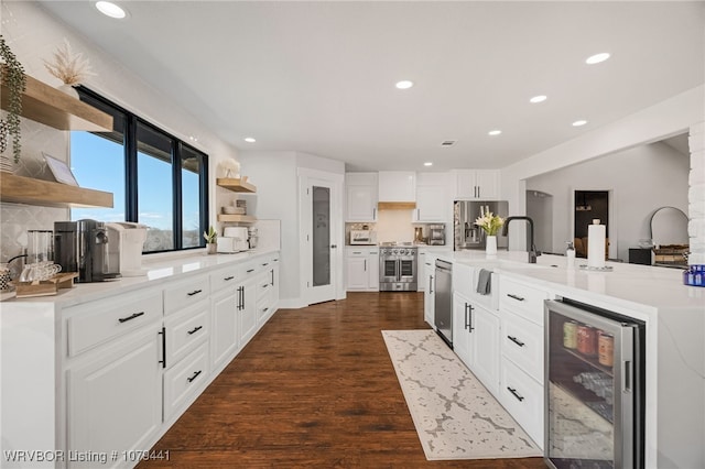 kitchen featuring wine cooler, dark wood-style flooring, stainless steel appliances, open shelves, and a sink