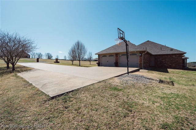 exterior space with brick siding, a yard, driveway, and an attached garage